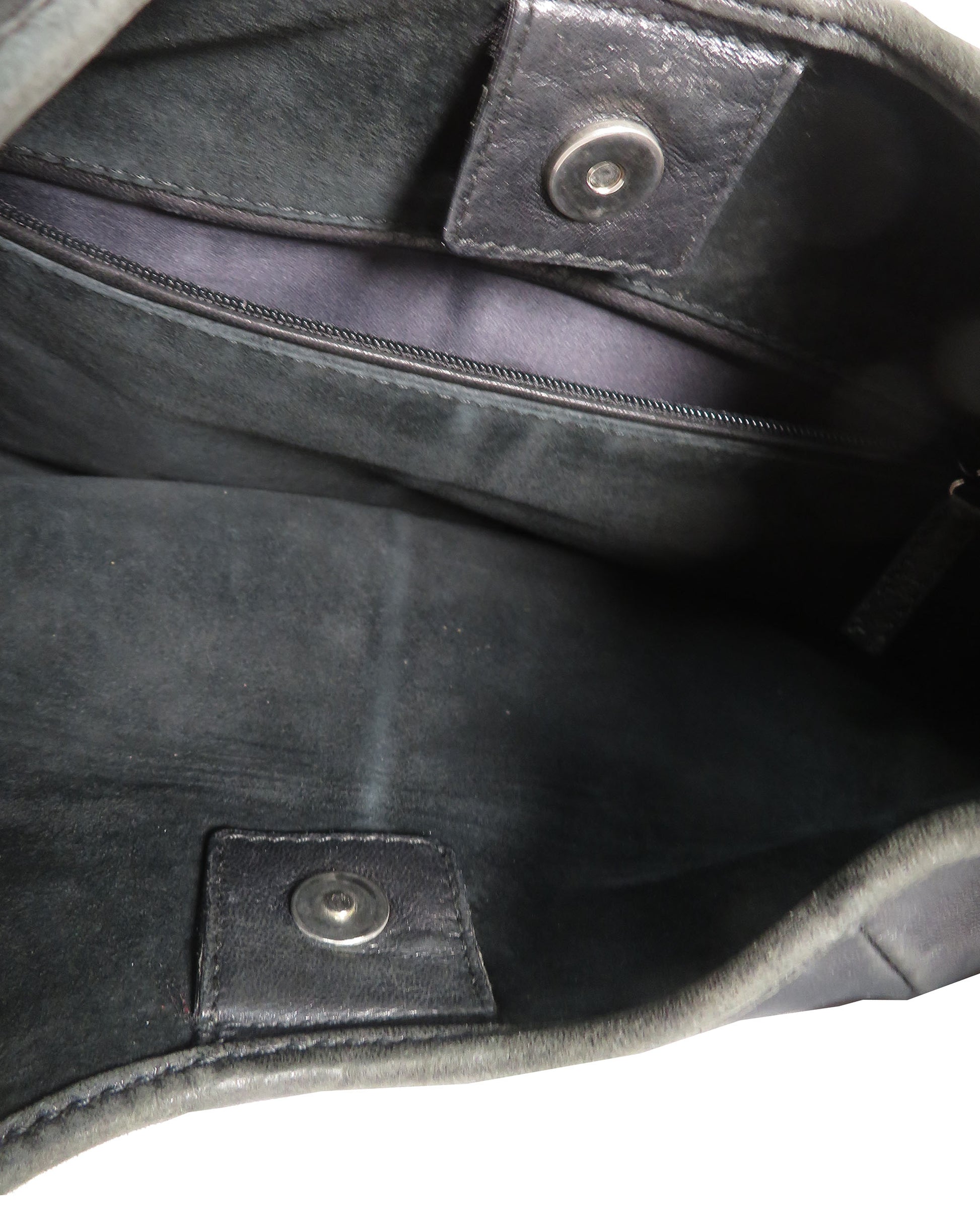 Close-up of a black leather bag with stitching details