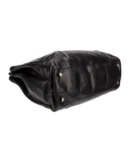 Black leather bag with studs on a white background